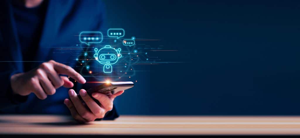 imagem mostra um homem mexendo em um celular tecnológico, com um símbolo de chatbot, associando o aparelho à inteligência artificial